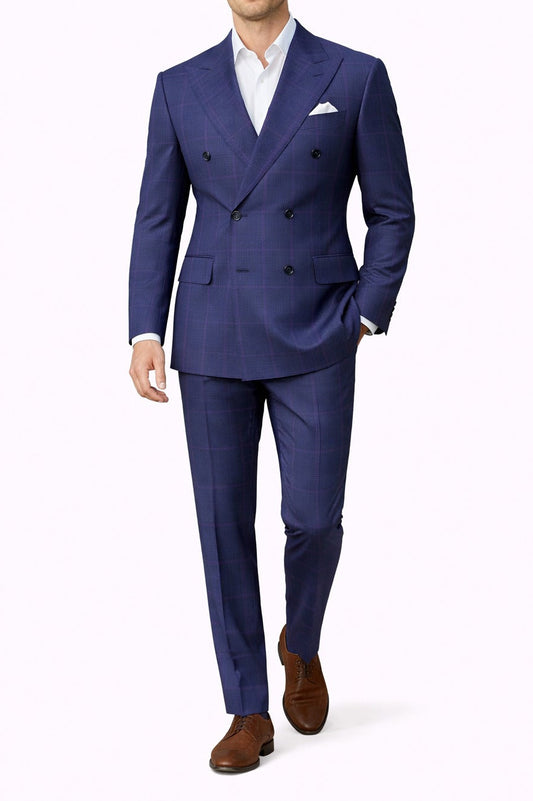 Man wearing a blue suit with a white shirt and brown shoes on a white background