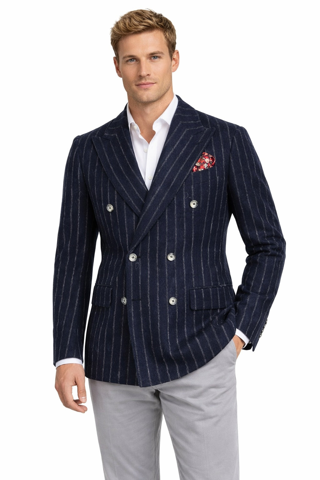 Man wearing a navy pinstripe blazer with a white shirt and light gray pants on a white background