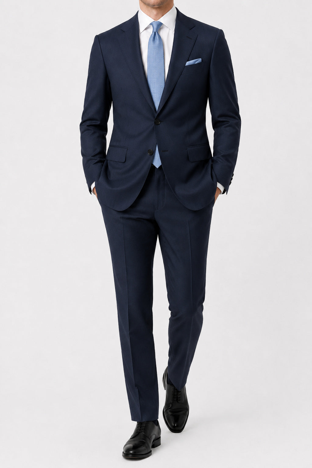 Navy suit with a light blue tie on a white background