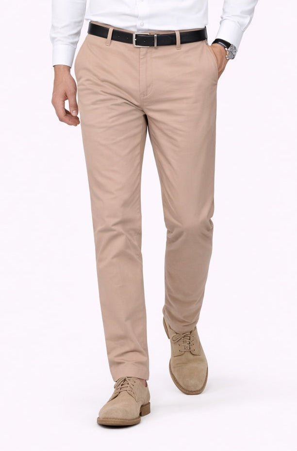 Man wearing a white shirt, beige pants, and brown shoes on a white background